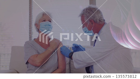 Injecting doctor delivering vaccine to senior female patient in medical office, with syringe Injecting doctor delivering vaccine to senior female patient in medical office, with syringe 135573812