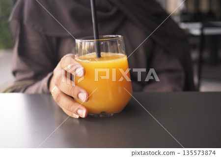Enjoying a drink at a cafe with friends in the afternoon Enjoying a drink at a cafe with friends in the afternoon 135573874