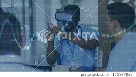 Gesturing physician in scrubs with VR headset demonstrating holographic charts in training room Gesturing physician in scrubs with VR headset demonstrating holographic charts in training room 135573922