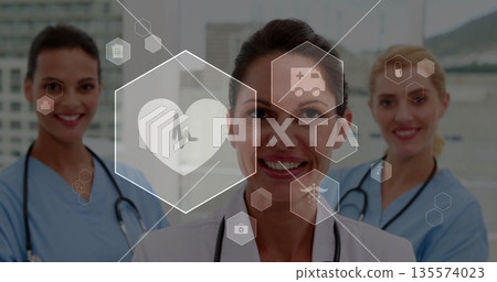 Standing female physician consulting team in hospital lobby, with stethoscopes and medical icons Standing female physician consulting team in hospital lobby, with stethoscopes and medical icons 135574023