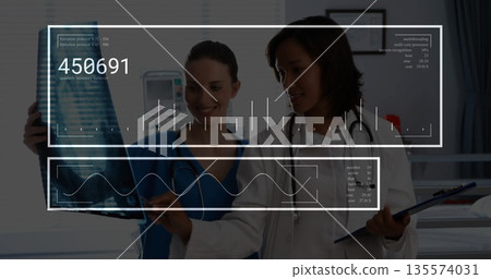 Reviewing radiographic scan, staff in clinic wearing scrubs and coat holding clipboard, stethoscope 135574031