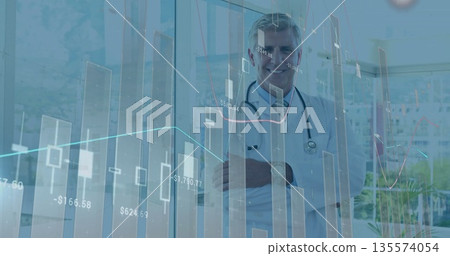 Standing doctor monitoring digital charts in clinic with windows wearing lab coat and stethoscope Standing doctor monitoring digital charts in clinic with windows wearing lab coat and stethoscope 135574054