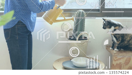 Woman in blouse watering cactus with watering can in living area, with data overlays, copy space 135574224