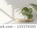 wooden product podium with green monstera leaf on white background 135574305