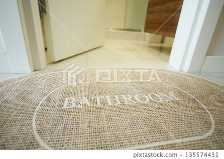 Cozy bathroom entrance mat with simple design in modern setting Cozy bathroom entrance mat with simple design in modern setting 135574431