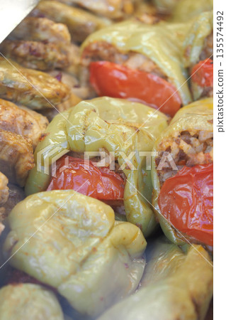 Stuffed peppers filled with meat and rice on a cooking tray Stuffed peppers filled with meat and rice on a cooking tray 135574492