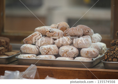 Cookies are stacked on a tray in a bakery display case Cookies are stacked on a tray in a bakery display case 135574508