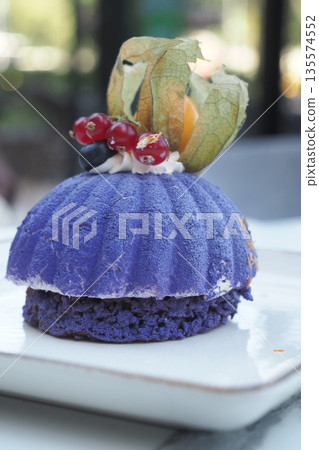 Dessert with purple dough and berry topping on a plate Dessert with purple dough and berry topping on a plate 135574552