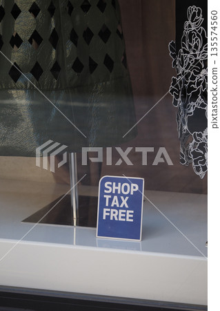 Shop tax-free sign in a store window display with clothing 135574560