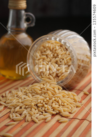 Raw Organic Risoni Pasta in a Bowl 135574609