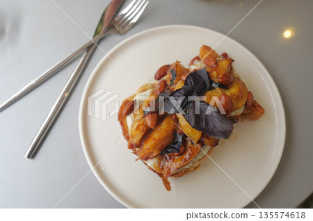 Delicious dessert served on a white plate with nuts 135574618