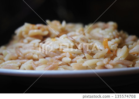 bulgur rice served in a white bowl in a dark setting bulgur rice served in a white bowl in a dark setting 135574708