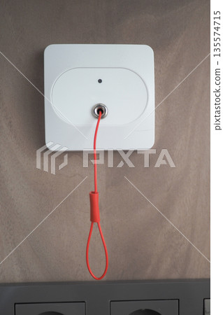 Safety device on wall for emergency situations in building Safety device on wall for emergency situations in building 135574715