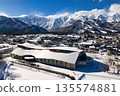 Kyowa Wing Hakuba (Wing 21) and the Hakuba mountain range, with snow rising from it. Hakuba Village, Nagano Prefecture (aerial photo taken by drone) 135574881