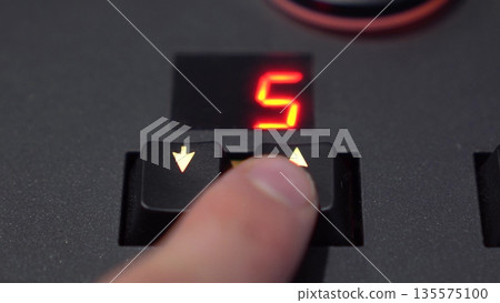 Close-Up Finger Changing Preset with Arrow Buttons on Lighting Mixer, 4K 135575100