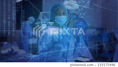 Female surgeon preparing hands in operating room, with data holograms and instrument tray 135575496