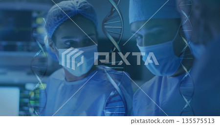 Standing surgical team wearing light blue scrubs in operating room, with overlaid DNA graphics Standing surgical team wearing light blue scrubs in operating room, with overlaid DNA graphics 135575513