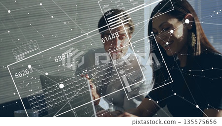 Two office professionals reviewing laptop screen with pen in office, with floating data panels Two office professionals reviewing laptop screen with pen in office, with floating data panels 135575656