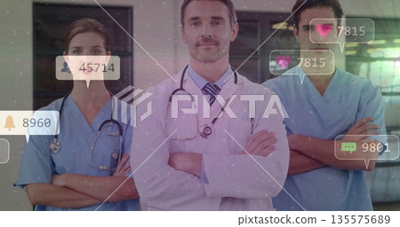 Standing medical team folding arms in clinical hallway, with stethoscopes notification icons Standing medical team folding arms in clinical hallway, with stethoscopes notification icons 135575689
