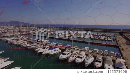 Displaying pleasure boats and sailboats mooring at wooden piers in marina with hexagonal overlay 135575696