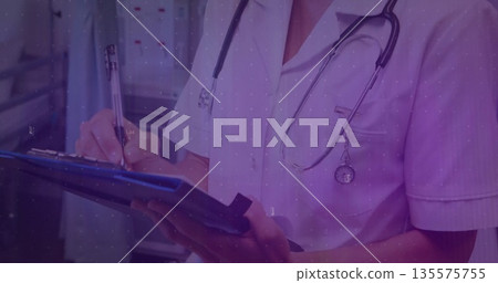 Writing nurse in scrubs using blue clipboard with pen in hospital corridor, with stethoscope Writing nurse in scrubs using blue clipboard with pen in hospital corridor, with stethoscope 135575755