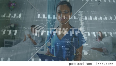 Indian nurse in blue scrubs reviewing data on tablet in hospital room, with stethoscope Indian nurse in blue scrubs reviewing data on tablet in hospital room, with stethoscope 135575766