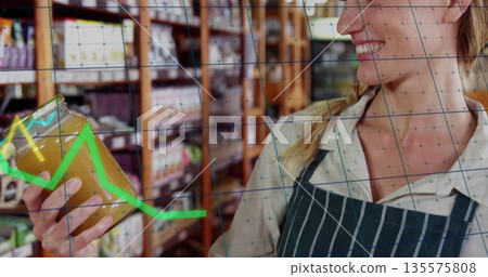 Inspecting clerk in apron holding glass jar in grocery aisle, shelves and graph overlay, copy space Inspecting clerk in apron holding glass jar in grocery aisle, shelves and graph overlay, copy space 135575808