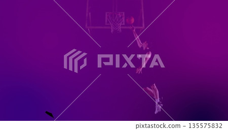 Basketball player dunking basketball in gym, with hoop net, jersey and athletic shoes, copy space 135575832