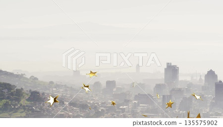 Featuring central skyline cluster shimmering through misty haze at hilltop, with gold star overlays 135575902