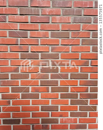 It's a wall made of red bricks. It's a wall made of red bricks. 135575971