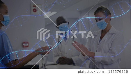 Medical team exchanging hand sanitizer in hospital corridor, wearing face masks, DNA helix graphics Medical team exchanging hand sanitizer in hospital corridor, wearing face masks, DNA helix graphics 135576326