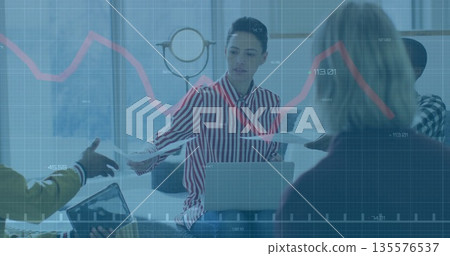 Passing printed documents Hispanic woman in striped blouse at office table, with laptop and tablet Passing printed documents Hispanic woman in striped blouse at office table, with laptop and tablet 135576537