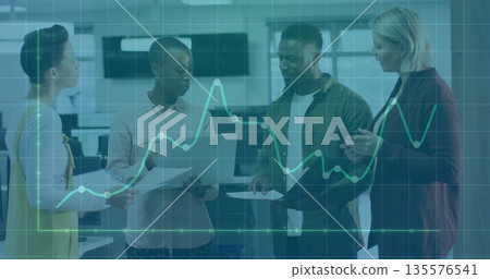 Discussing team reviewing performance metrics in modern office, with laptop reports and data graph 135576541