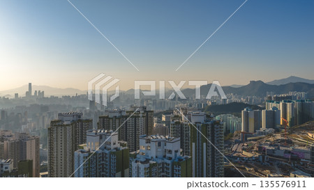 Jan 11 2026 Kwun Tong skyline glowing under vibrant evening sunset 135576911