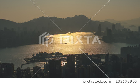 Jan 11 2026 Golden Twilight Over Kowloon Bay Skyline and Harbor Waters Jan 11 2026 Golden Twilight Over Kowloon Bay Skyline and Harbor Waters 135576916