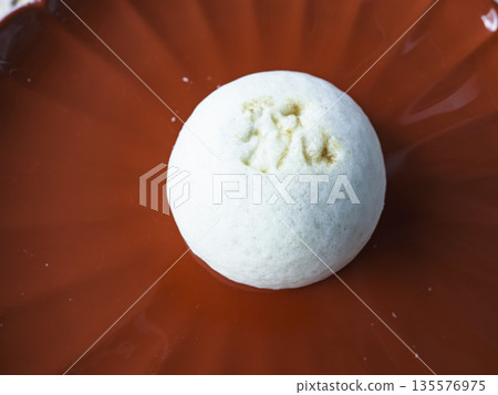 Bring good fortune! Refined white buns shining on a red plate Bring good fortune! Refined white buns shining on a red plate 135576975