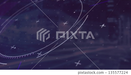 Displaying HUD rings and plus markers over blurred urban street at night, showing faint grid lines 135577224