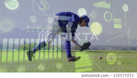Crouching baseball player in blue-white uniform fielding ball in outfield with glove data overlay 135577252