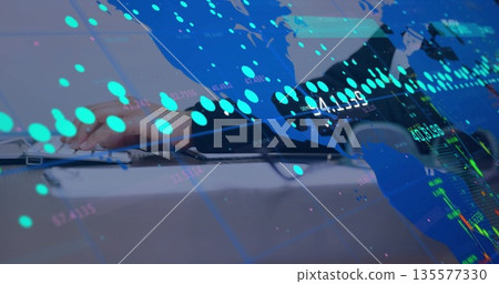 Typing woman wearing dark blazer at office desk, with silver laptop keyboard, market chart overlays Typing woman wearing dark blazer at office desk, with silver laptop keyboard, market chart overlays 135577330