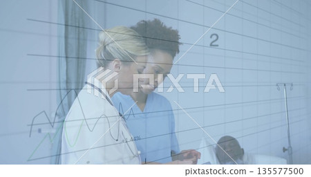 Staff wearing uniform reviewing tablet in hospital, with stethoscope, bed and IV stand, copy space Staff wearing uniform reviewing tablet in hospital, with stethoscope, bed and IV stand, copy space 135577500