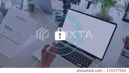 Reviewing woman holding Quarterly Report in office, with silver laptop and succulent, copy space 135577504