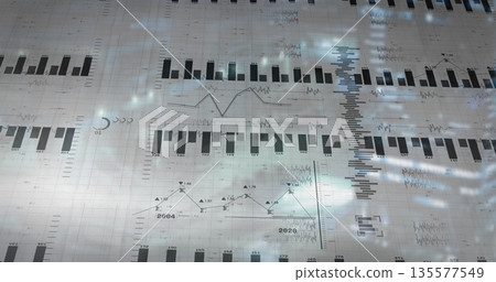 Projecting semi-transparent grid over blurred backdrop, showing bar charts, line graphs, sparklines 135577549