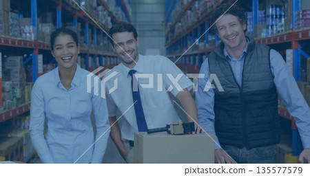 Smiling three warehouse workers standing in warehouse aisle, with cardboard box and tape dispenser Smiling three warehouse workers standing in warehouse aisle, with cardboard box and tape dispenser 135577579