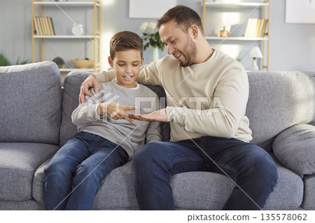 Young father and little child son playing rock paper scissors together at home Young father and little child son playing rock paper scissors together at home 135578062