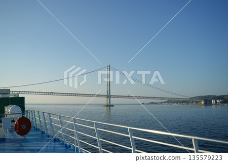 Ferry deck and Akashi Kaikyo Bridge 135579223