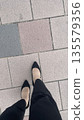 Woman walking in heels 135579356