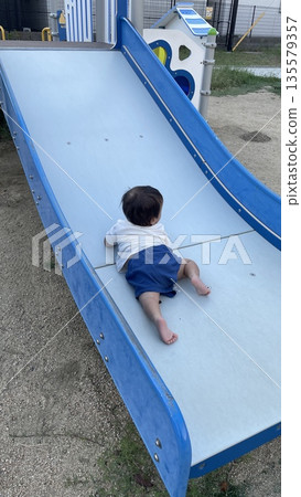Infants playing in the park 135579357