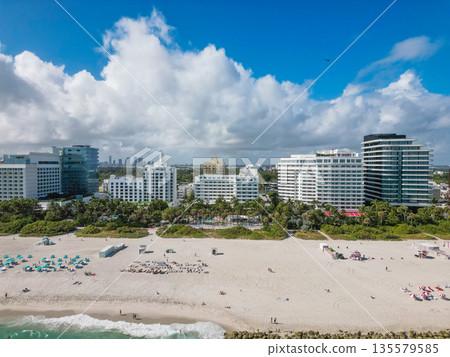 Aerial view of Miami city by the coast. Miami skyline with oceanfront skyscrapers. Scenic Miami panorama of Florida famous coastline. Drone shot of Miami above the shore. Aerial view of Miami city by the coast. Miami skyline with oceanfront skyscrapers. Scenic Miami panorama of Florida famous coastline. Drone shot of Miami above the shore. 135579585