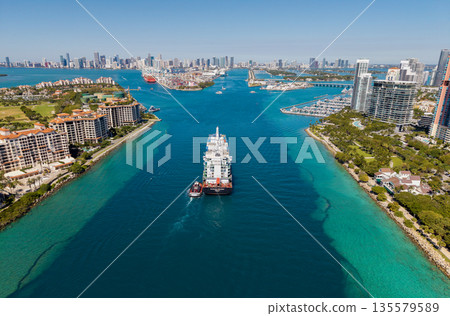 Miami, Florida, USA - March 20, 2025: Freight container cargo vessel and tugboat. Cargo ship vessel. Miami port. Container Monrovia ship. Cargo Seaboard Explorer container ship, sea transportation 135579589
