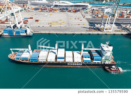 Miami, Florida, USA - March 20, 2025: Freight container cargo vessel and tugboat. Cargo ship vessel. Miami port. Container Monrovia ship. Cargo Seaboard Explorer container ship, sea transportation 135579590